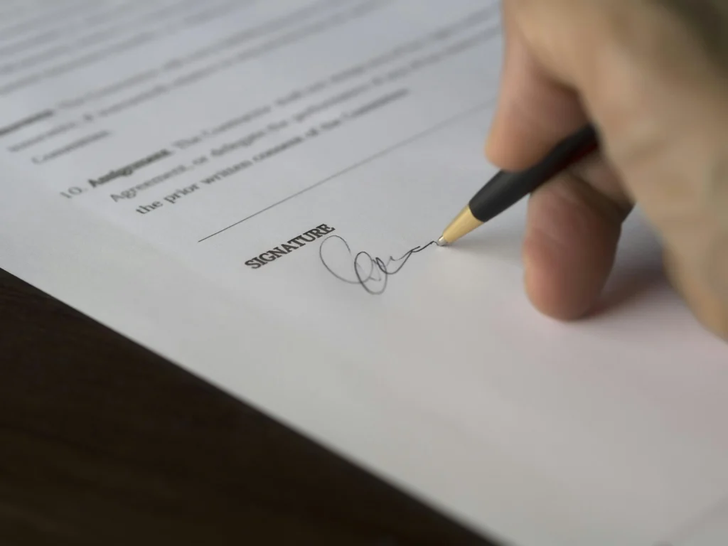 Client signing property agreement document – Saini Properties